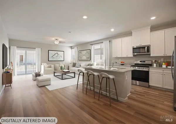 a kitchen with sink a refrigerator and microwave