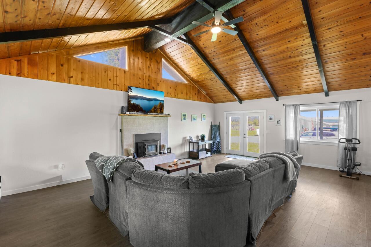 380 Greenleaf Drive Eagle Point, OR 97524 - Photo 12 of 31 a living room with fireplace furniture and a floor to ceiling window