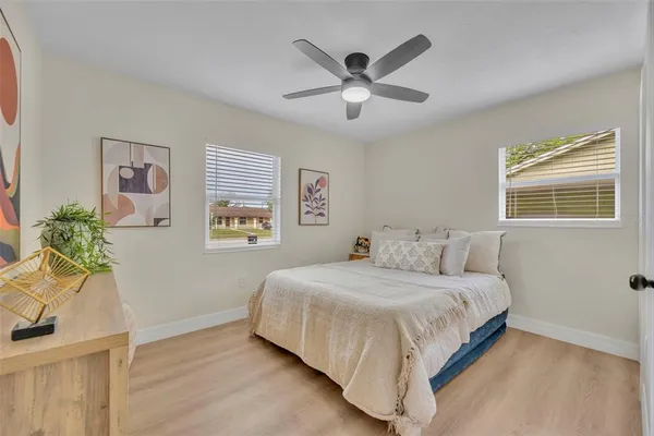 a bedroom with a bed and painting on the wall