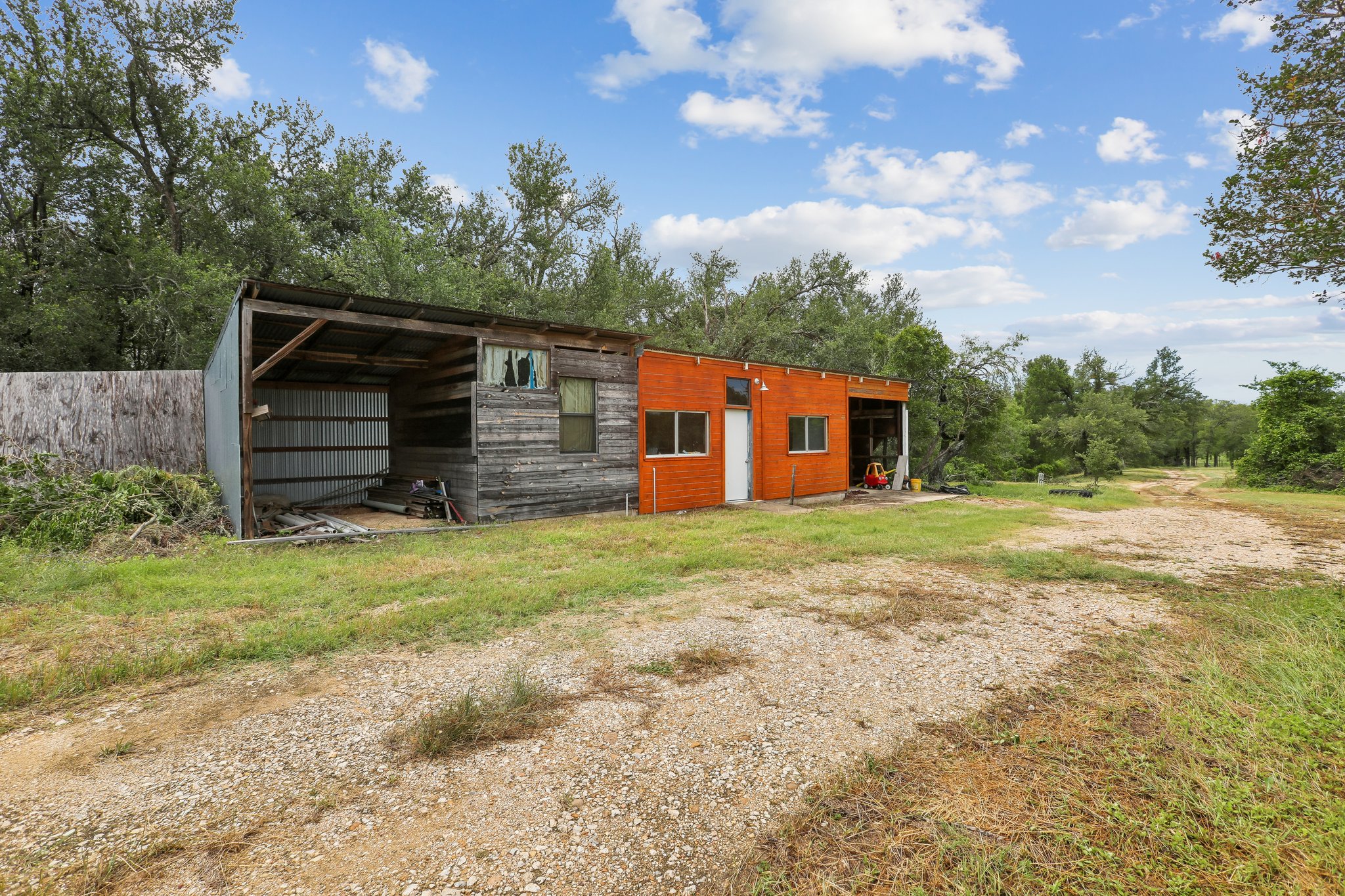 406 Monkey Road Elgin, TX 78621 - Photo 29 of 39 Detached structure featuring a wood facade, corrugated metal siding, and an orange painted section