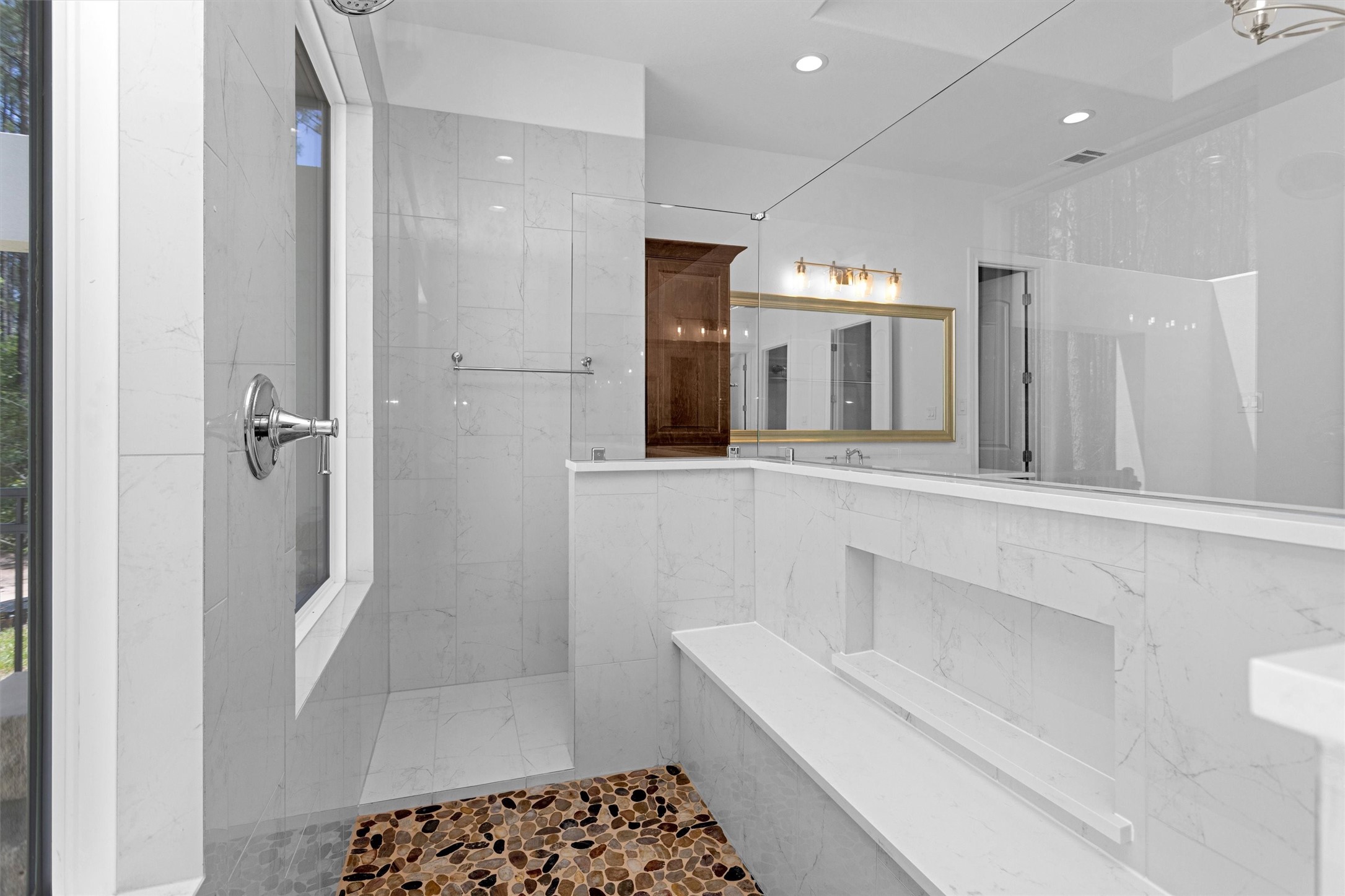 16081 Forest Mill Road Willis, TX 77378 - Photo 16 of 39 a bathroom with a sink a toilet a shower and mirror