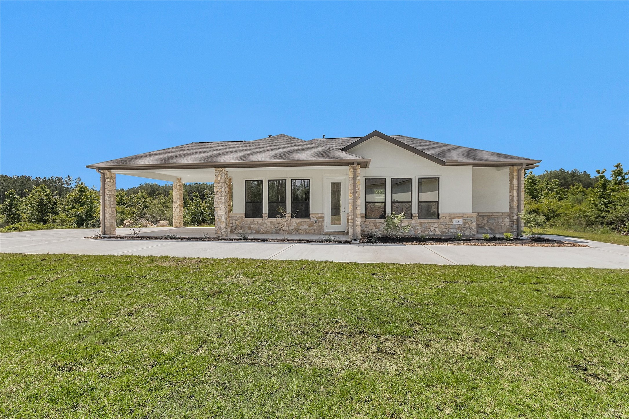 16081 Forest Mill Road Willis, TX 77378 - Photo 29 of 39 a front view of a house with a garden