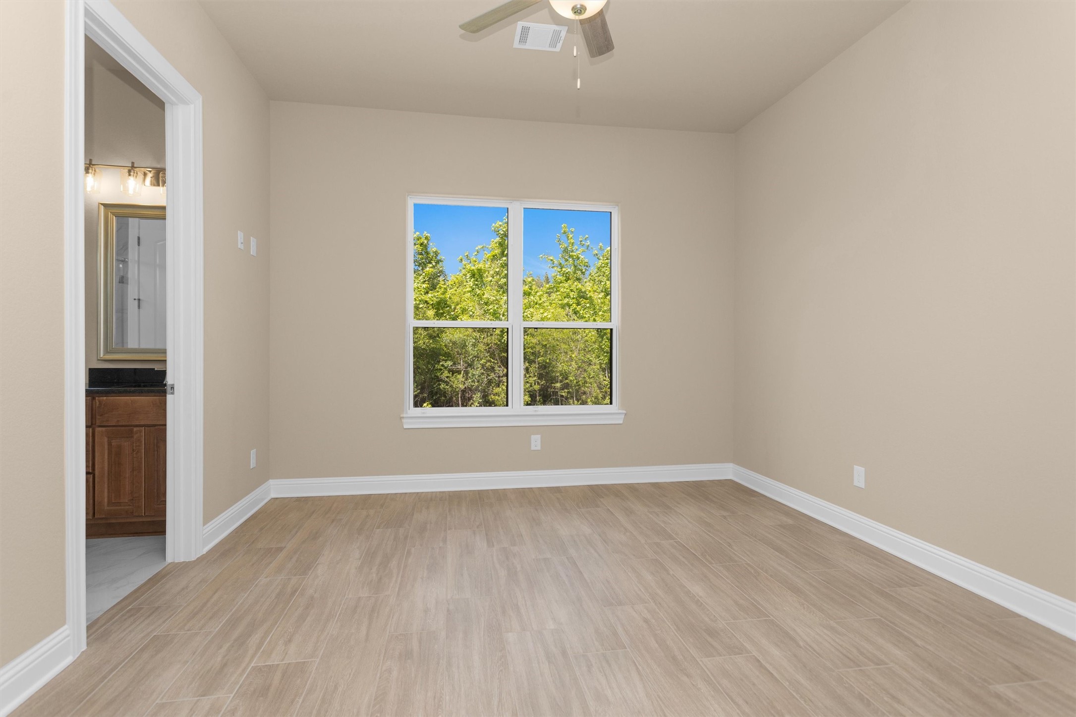 16081 Forest Mill Road Willis, TX 77378 - Photo 32 of 39 wooden floor in an empty room with a window