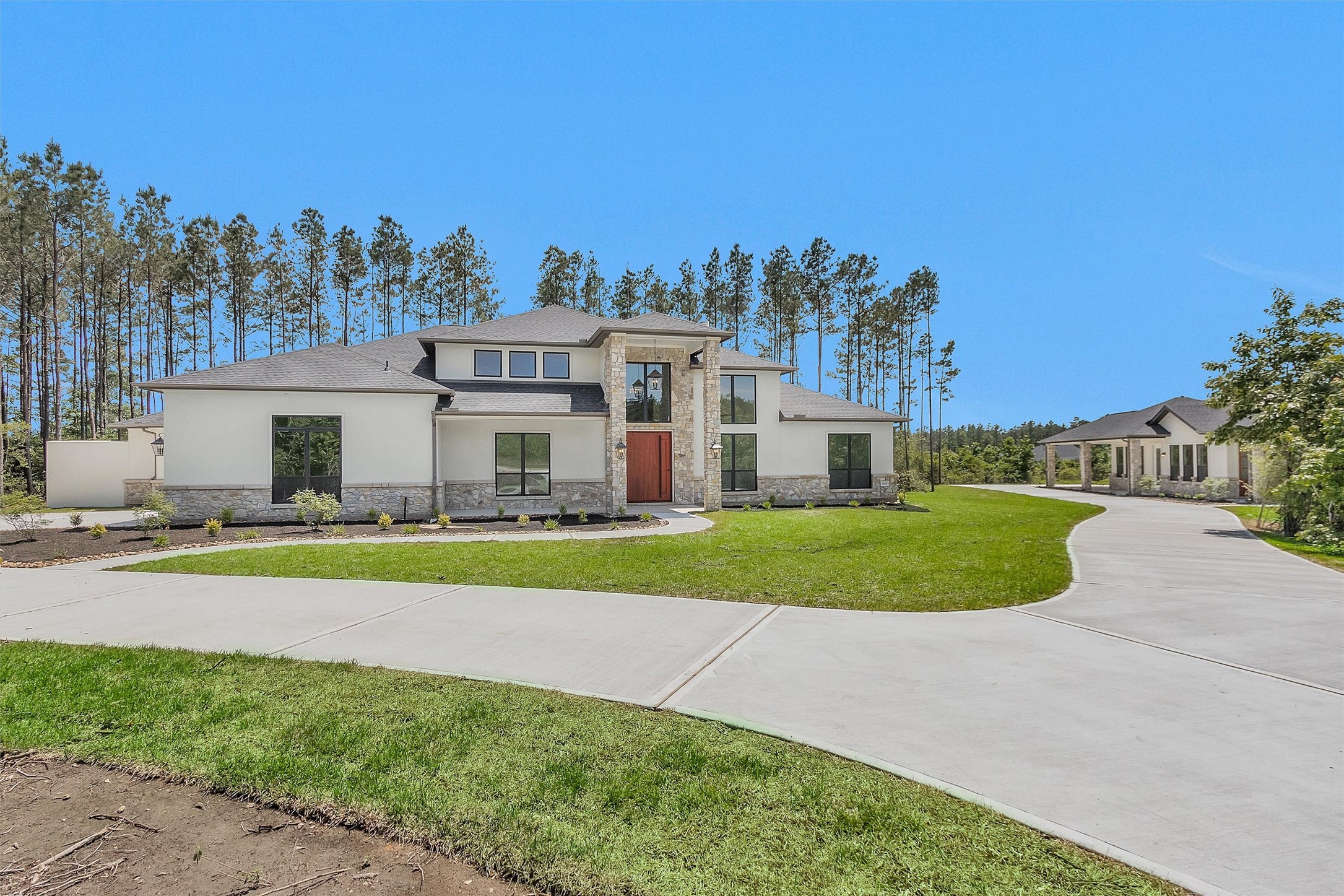 16081 Forest Mill Road Willis, TX 77378 - Photo 37 of 39 a front view of a house with a yard and garage