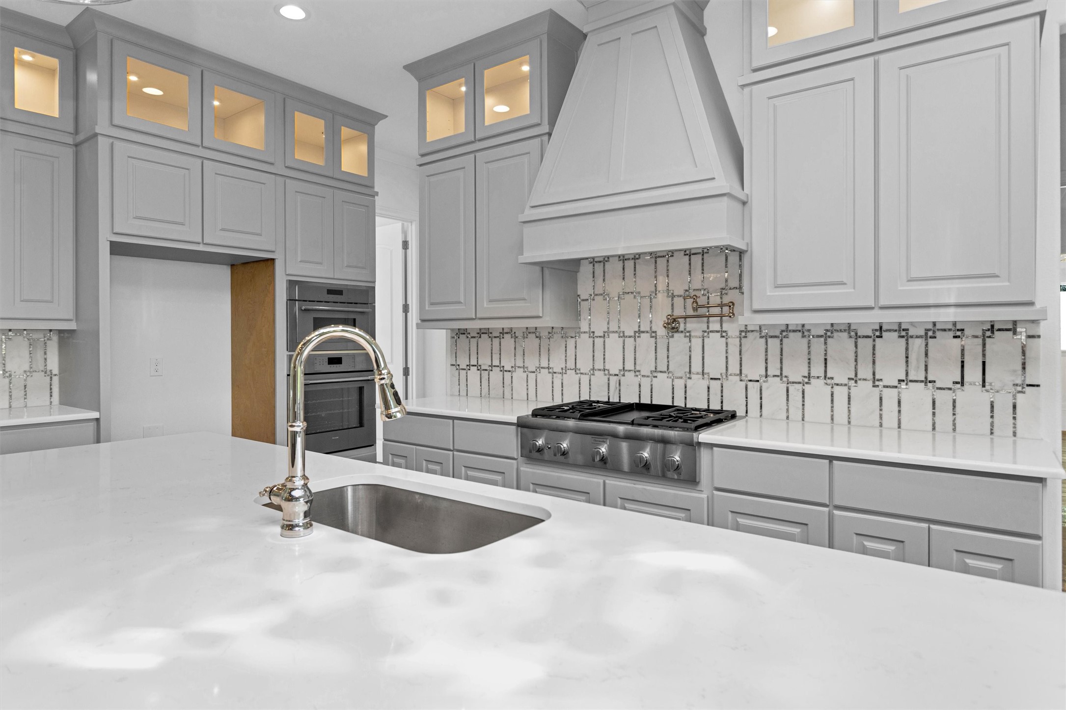 16081 Forest Mill Road Willis, TX 77378 - Photo 10 of 39 a kitchen with stainless steel appliances a sink a stove and white cabinets