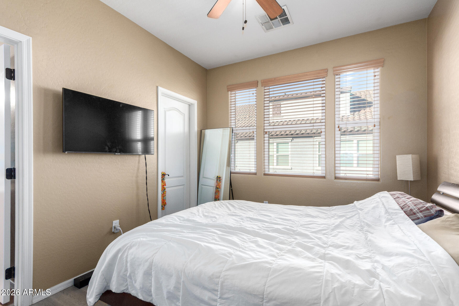 2257 East Huntington Drive Phoenix, AZ 85040 - Photo 17 of 25 a bedroom with a bed and a flat screen tv