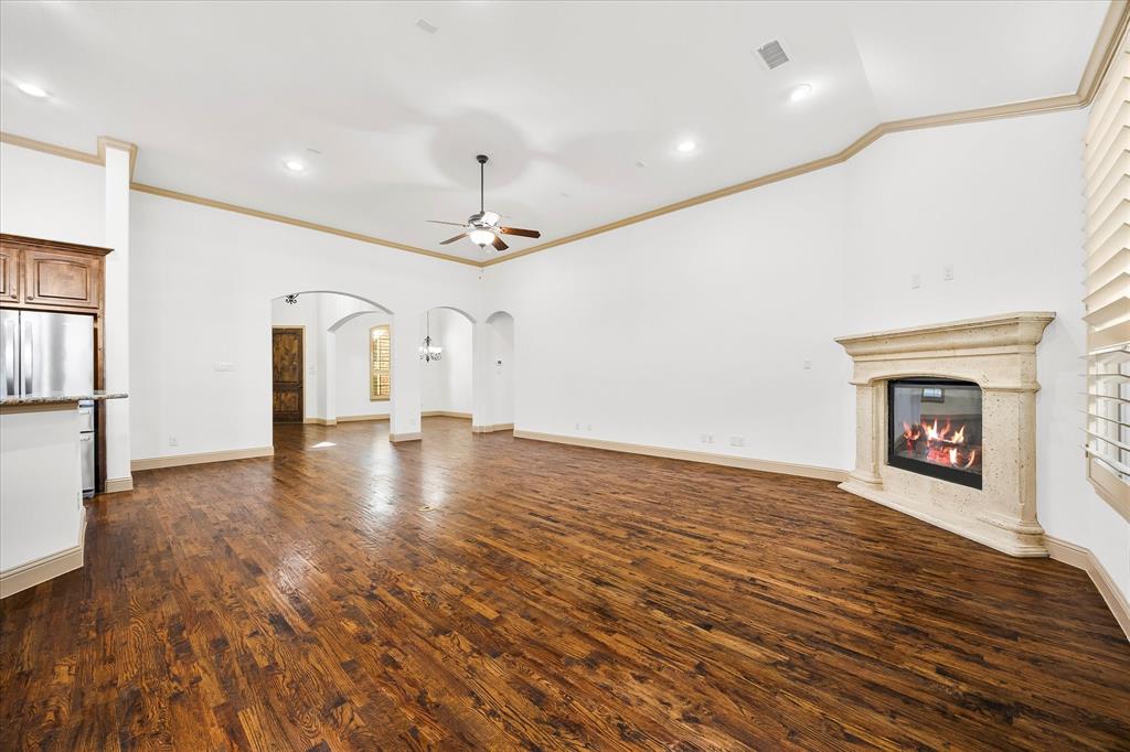 6814 Springwood Lane Garland, TX 75044 - Photo 14 of 35 a view of empty room with wooden floor and fireplace
