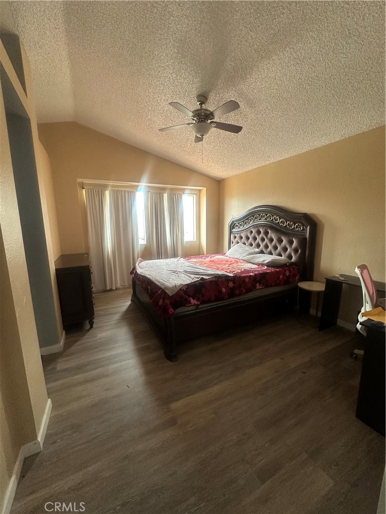 5147 Moonraker Road Palmdale, CA 93552 - Photo 11 of 21 a bedroom with a bed and a chandelier