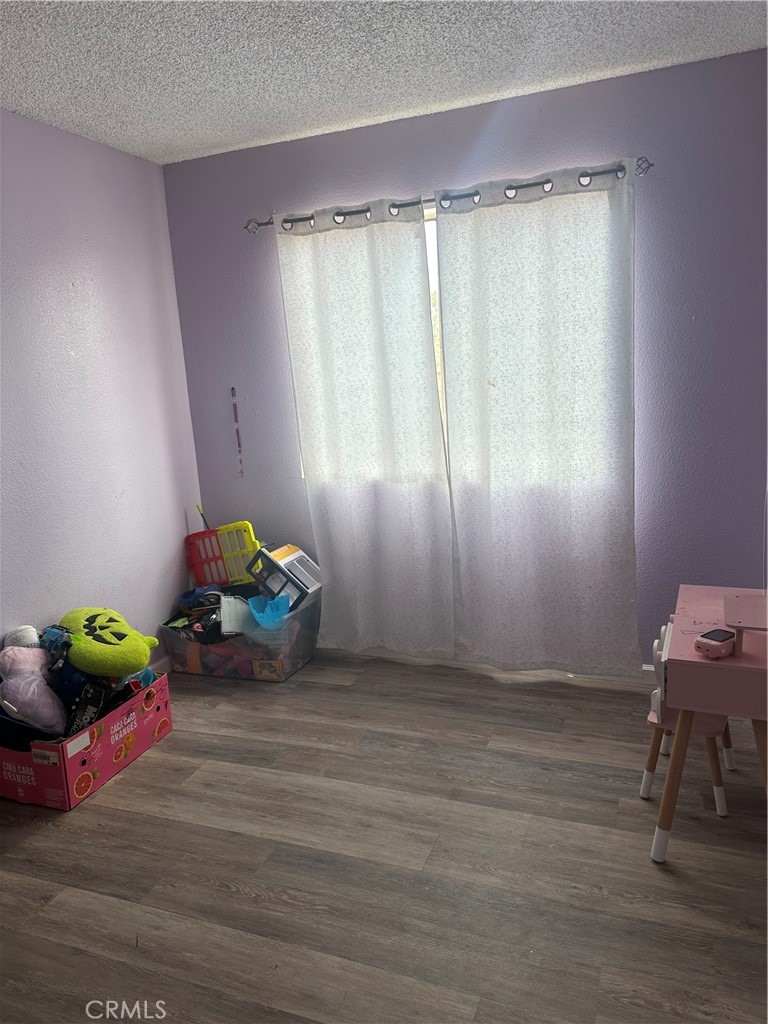 5147 Moonraker Road Palmdale, CA 93552 - Photo 16 of 21 a view of room with toys and wooden floor