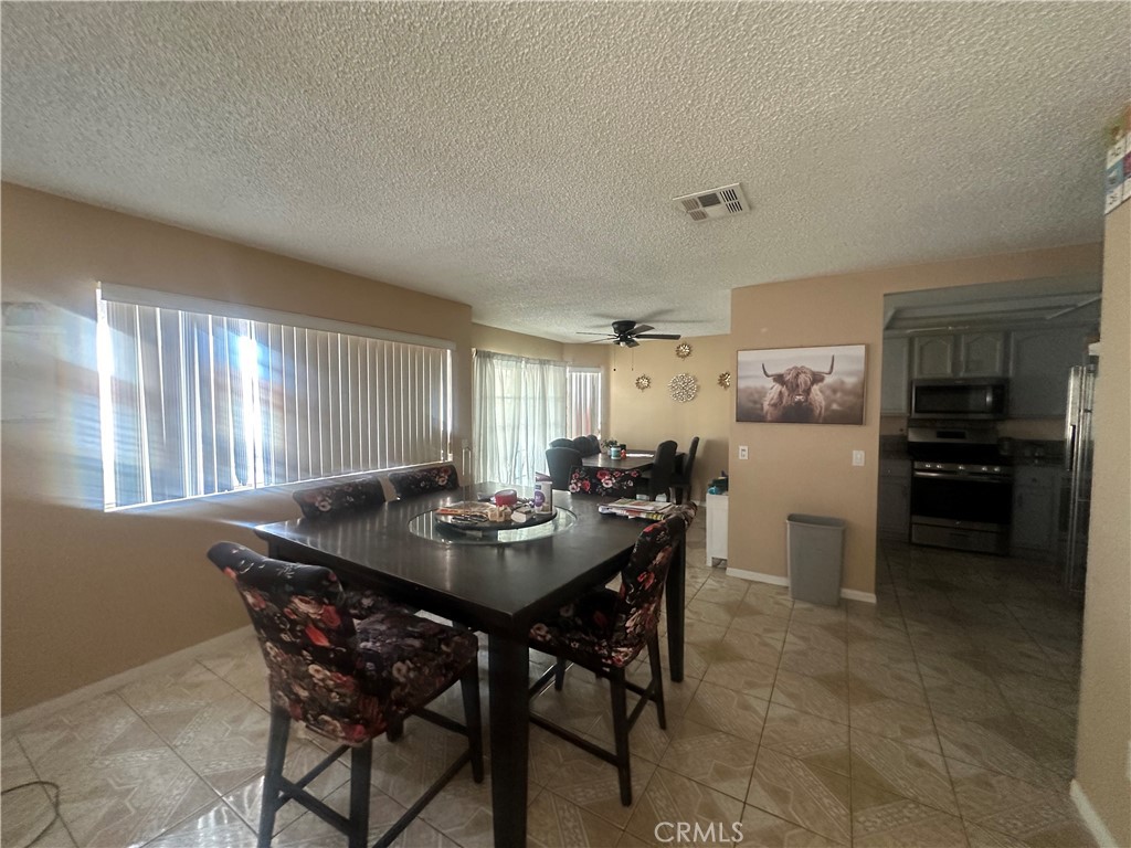 5147 Moonraker Road Palmdale, CA 93552 - Photo 5 of 21 a view of a dining room and livingroom view with furniture window and wooden floor