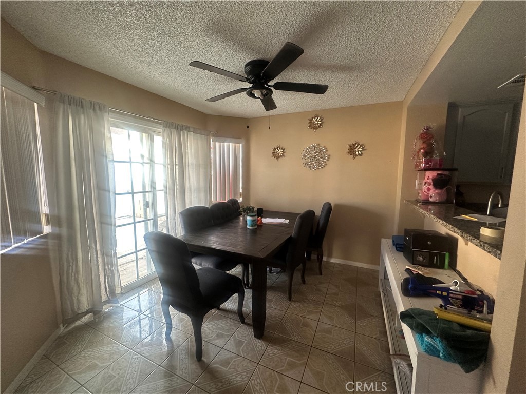 5147 Moonraker Road Palmdale, CA 93552 - Photo 8 of 21 a view of a dining room with furniture and a window