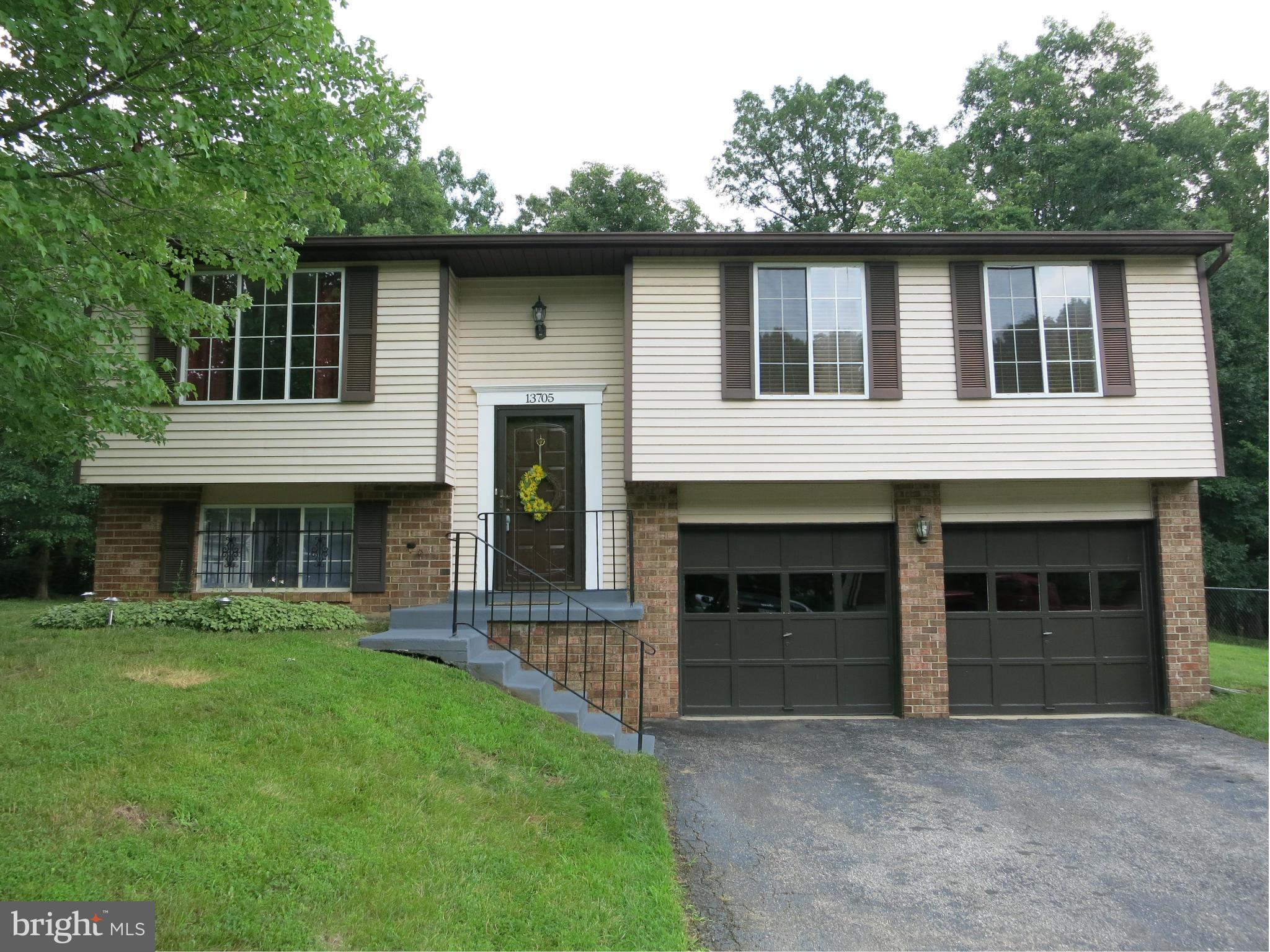 13705 Engleman Drive Laurel, MD 20708 - Photo 1 of 30 a front view of a house with a garden and yard