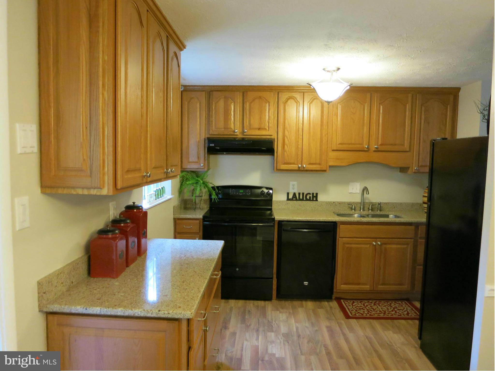 13705 Engleman Drive Laurel, MD 20708 - Photo 12 of 30 a kitchen with granite countertop cabinets stainless steel appliances a sink and wooden floor