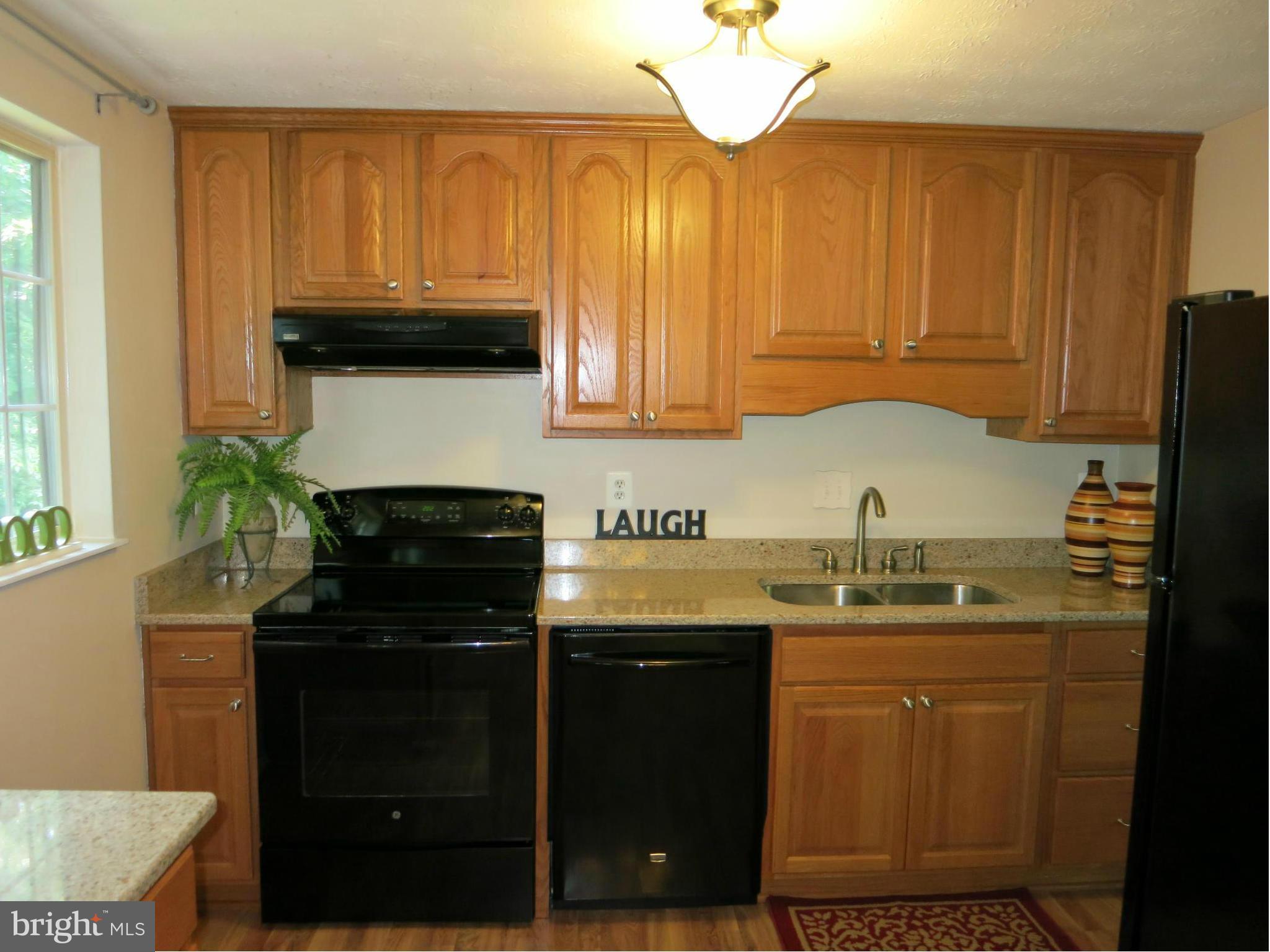 13705 Engleman Drive Laurel, MD 20708 - Photo 14 of 30 a kitchen with a sink a stove and cabinets