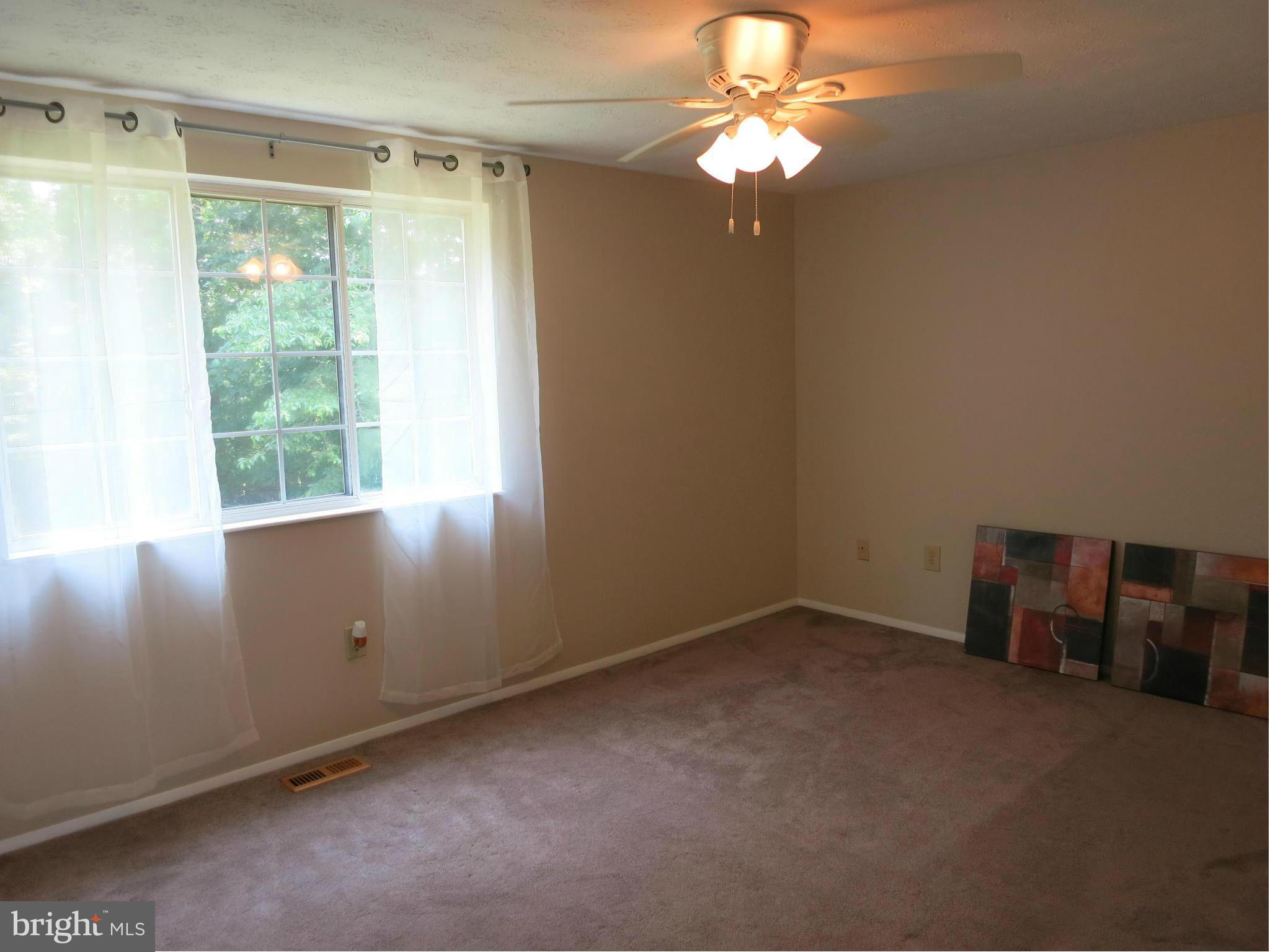 13705 Engleman Drive Laurel, MD 20708 - Photo 17 of 30 an empty room with windows and fan