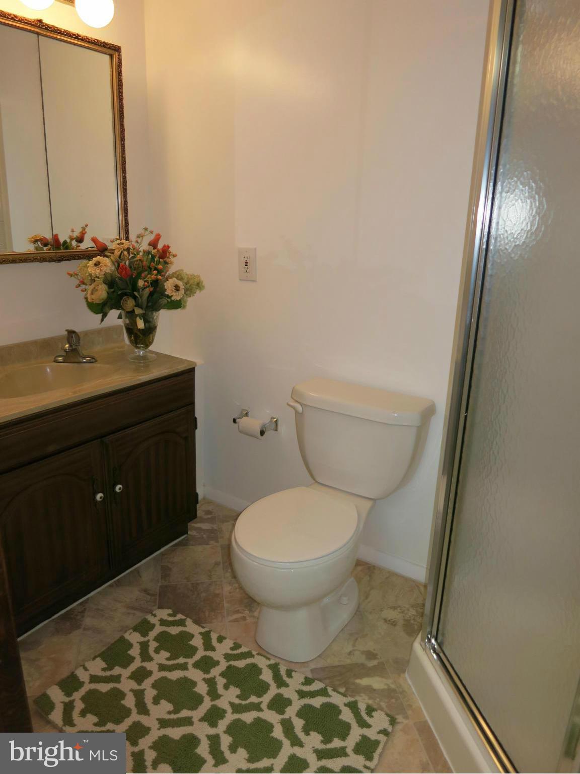 13705 Engleman Drive Laurel, MD 20708 - Photo 26 of 30 a bathroom with a toilet sink and mirror