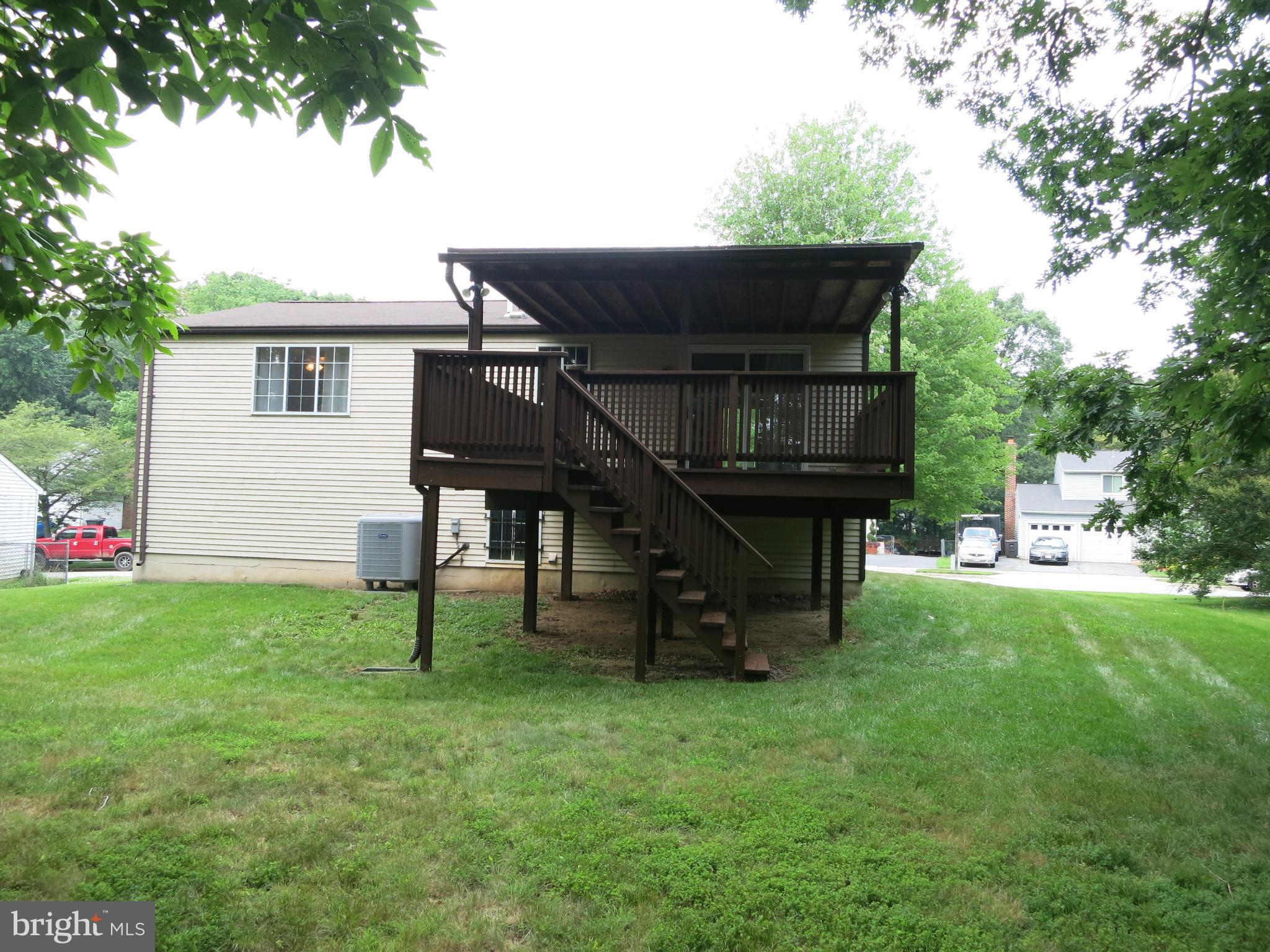 13705 Engleman Drive Laurel, MD 20708 - Photo 30 of 30 a view of backyard of house with wooden deck and seating space