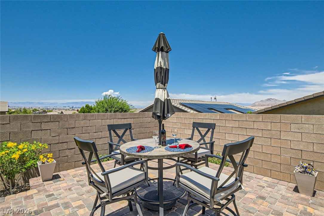 498 Pebble Run Avenue Henderson, NV 89011 - Photo 25 of 47 Enjoy outdoor dining and mountain views from this delightful patio with pavers and a privacy wall.