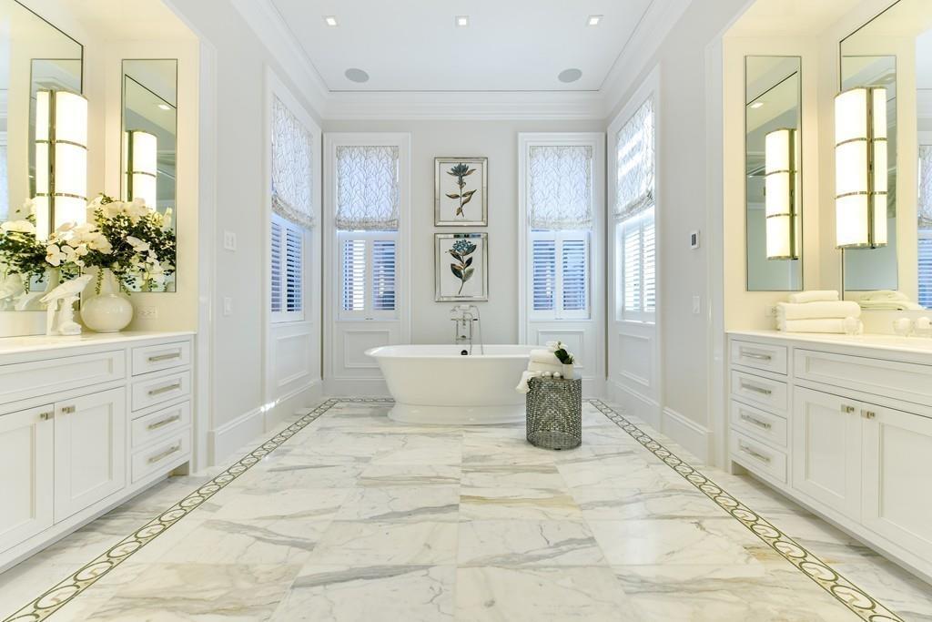 175 Beacon Street Boston, MA 02116 - Photo 23 of 35 a spacious bathroom with a granite countertop sink a mirror a bathtub and next to a window