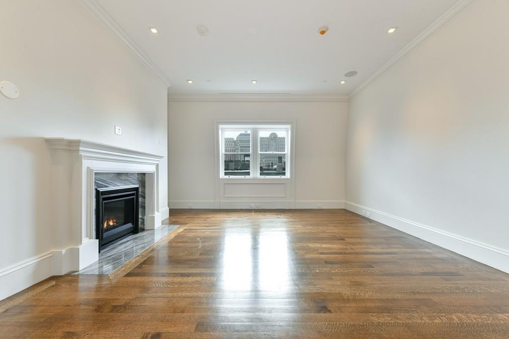 175 Beacon Street Boston, MA 02116 - Photo 27 of 35 a view of an empty room with wooden floor fireplace and a window