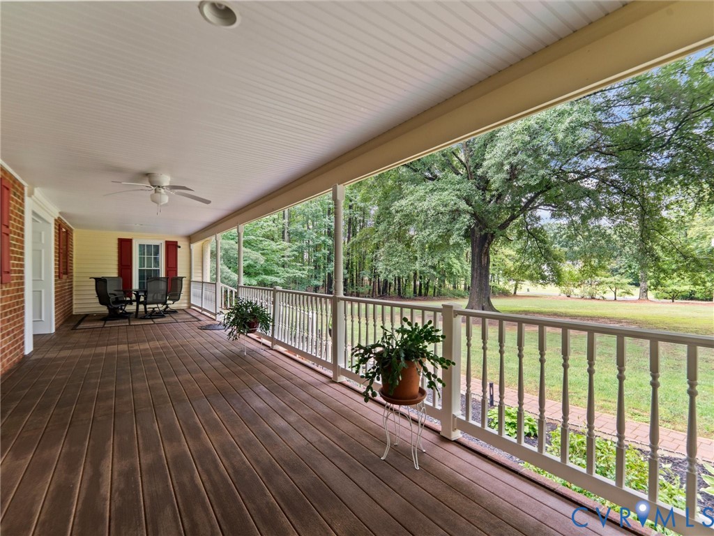 3420 State Rte 656 Powhatan, VA 23139 - Photo 4 of 37 a view of a patio with table and chairs next to a yard with wooden floor
