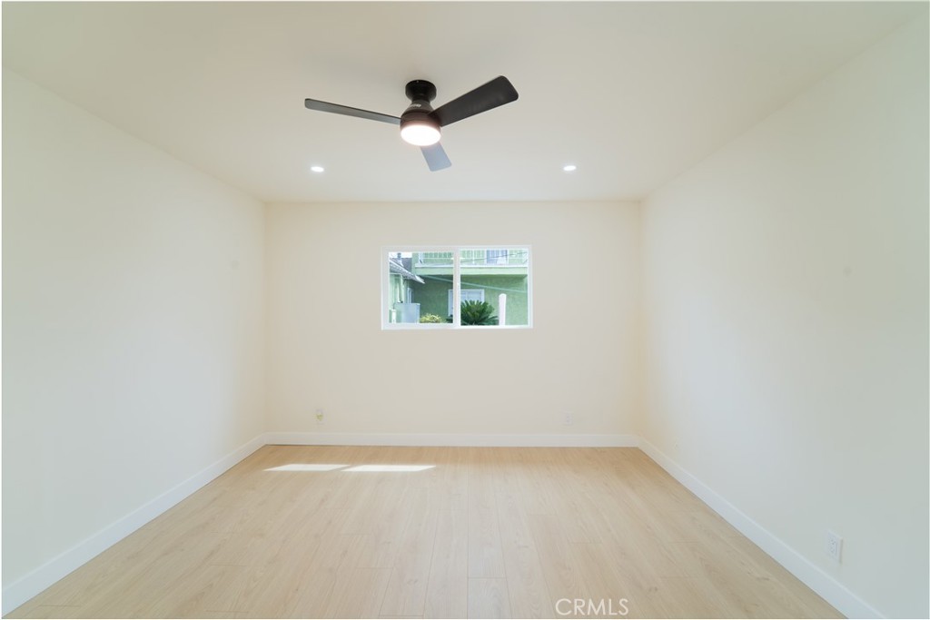 2204 West 153rd Street Compton, CA 90220 - Photo 16 of 21 an empty room with a ceiling fan and window