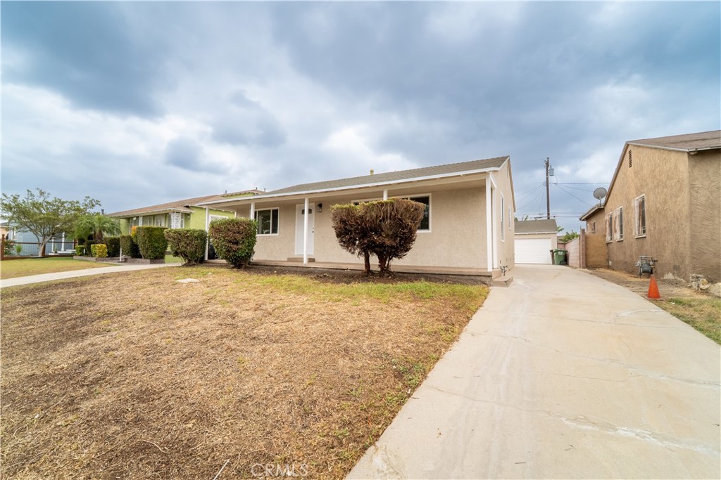 2204 West 153rd Street Compton, CA 90220 - Photo 3 of 21 a view of a house with backyard and a garden