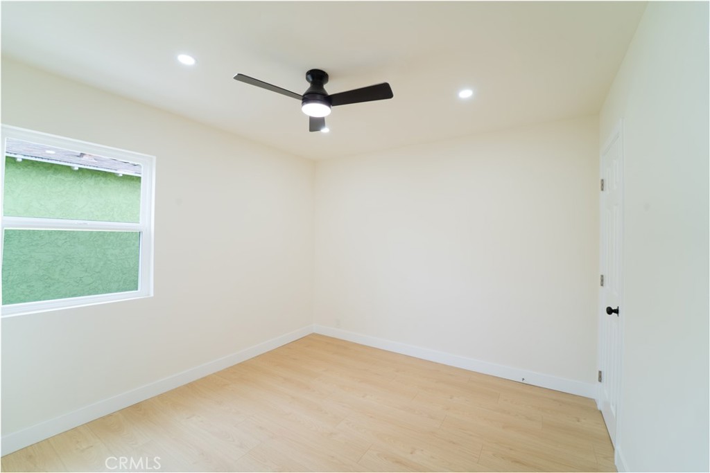 2204 West 153rd Street Compton, CA 90220 - Photo 10 of 21 an empty room with a window and a ceiling fan