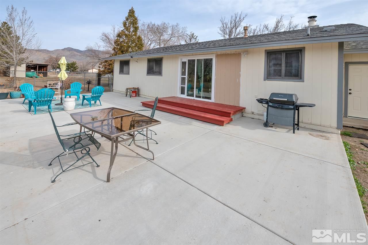 304 River Boat Road Dayton, NV 89403 - Photo 12 of 20 a view of a patio with a table and chairs under an umbrella