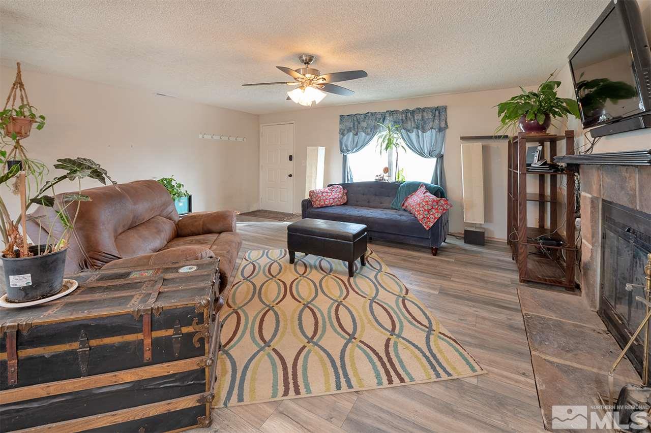 304 River Boat Road Dayton, NV 89403 - Photo 4 of 20 a living room with furniture a flat screen tv and a fireplace