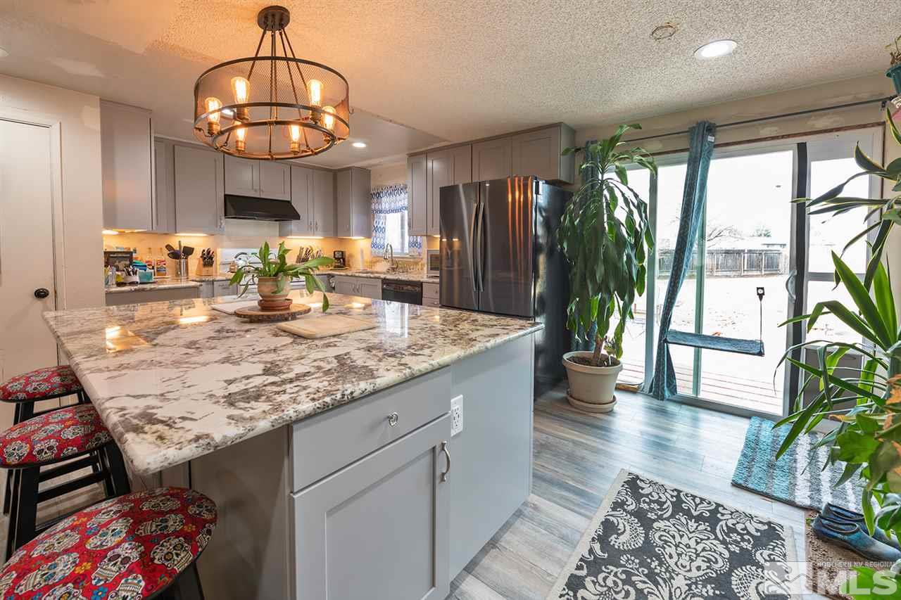 304 River Boat Road Dayton, NV 89403 - Photo 6 of 20 a view of a dining room and hall with wooden floor