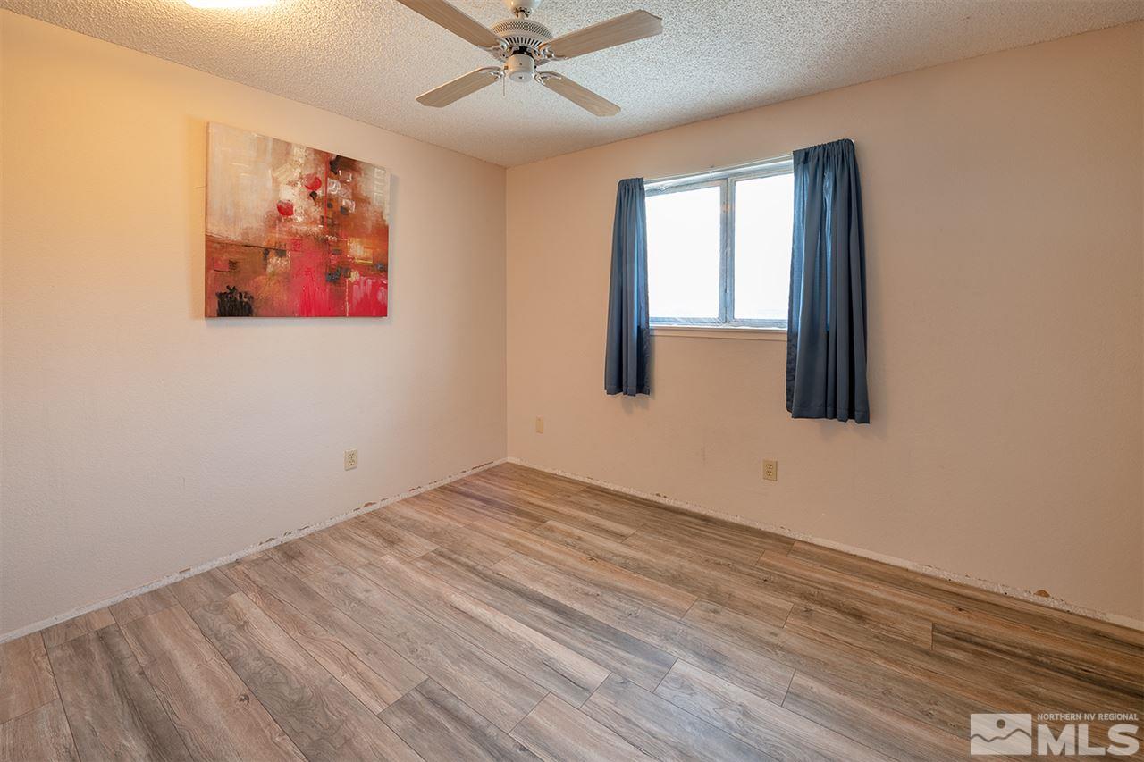 304 River Boat Road Dayton, NV 89403 - Photo 8 of 20 an empty room with wooden floor fan and windows