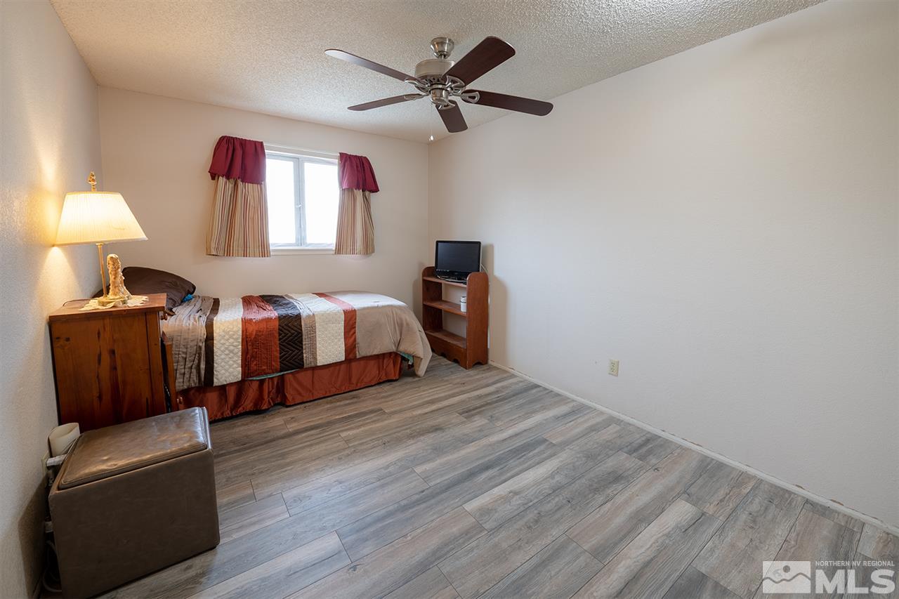 304 River Boat Road Dayton, NV 89403 - Photo 9 of 20 a spacious bedroom with a bed and a chandelier