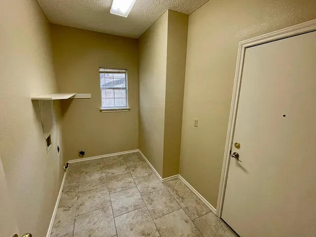 a kitchen with granite countertop a refrigerator a stove top oven a sink and dishwasher