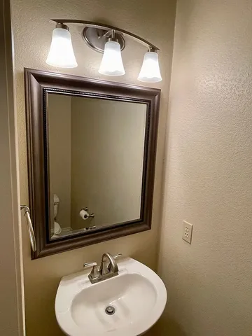 a bathroom with a sink and mirror