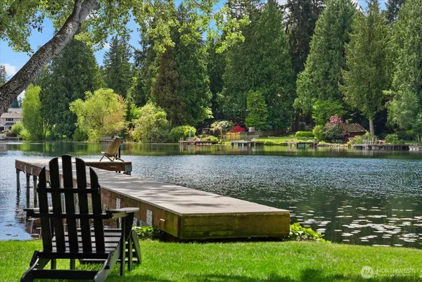 a view of house with backyard and sitting area