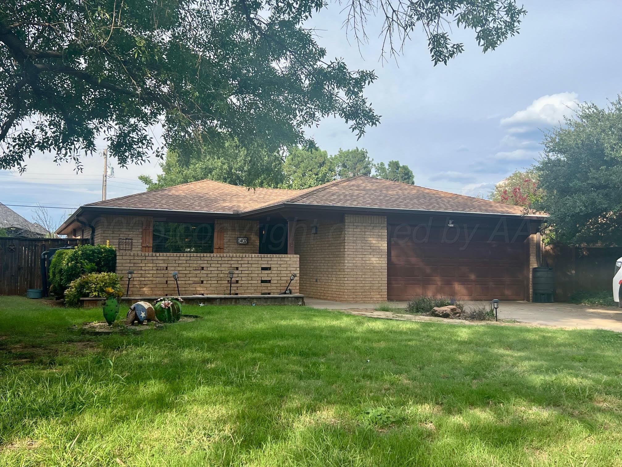 1402 Ave K Northwest Childress, TX 79201 - Photo 1 of 34 a front view of a house with a garden and trees