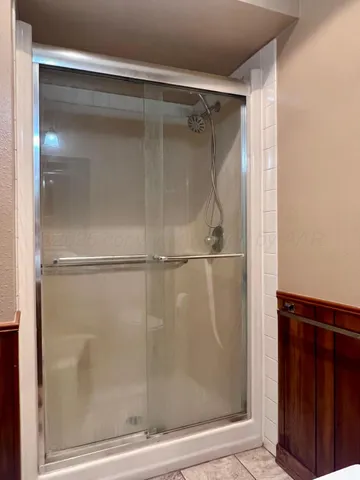 a bathroom with a glass shower door