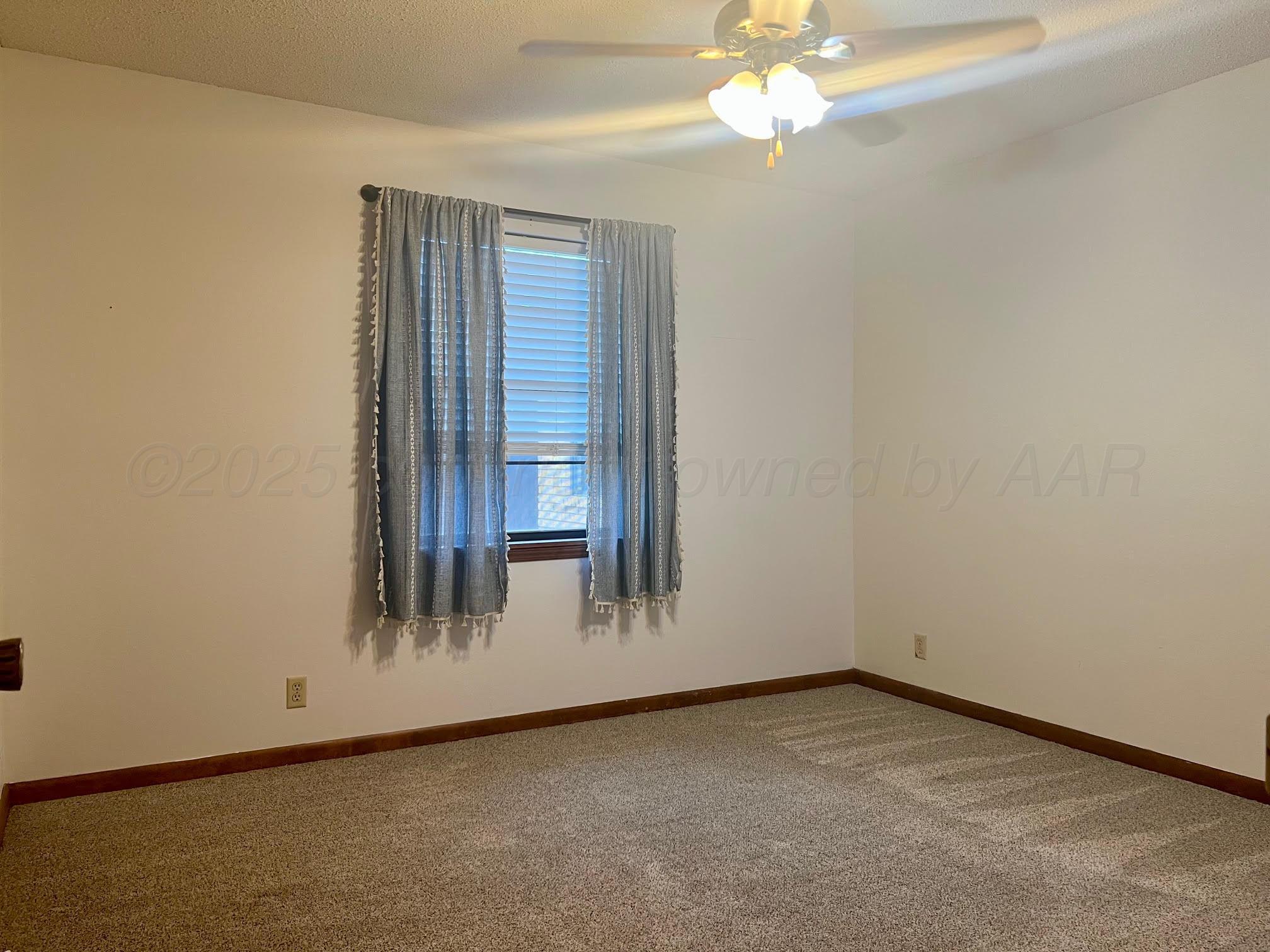 1402 Ave K Northwest Childress, TX 79201 - Photo 13 of 34 an empty room with a window