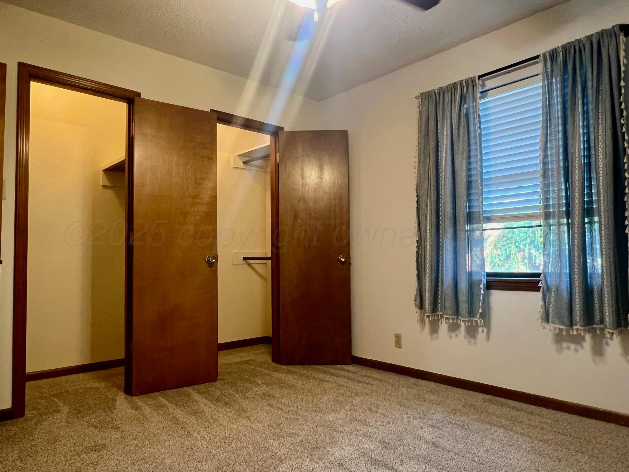 1402 Ave K Northwest Childress, TX 79201 - Photo 14 of 34 an empty room with windows