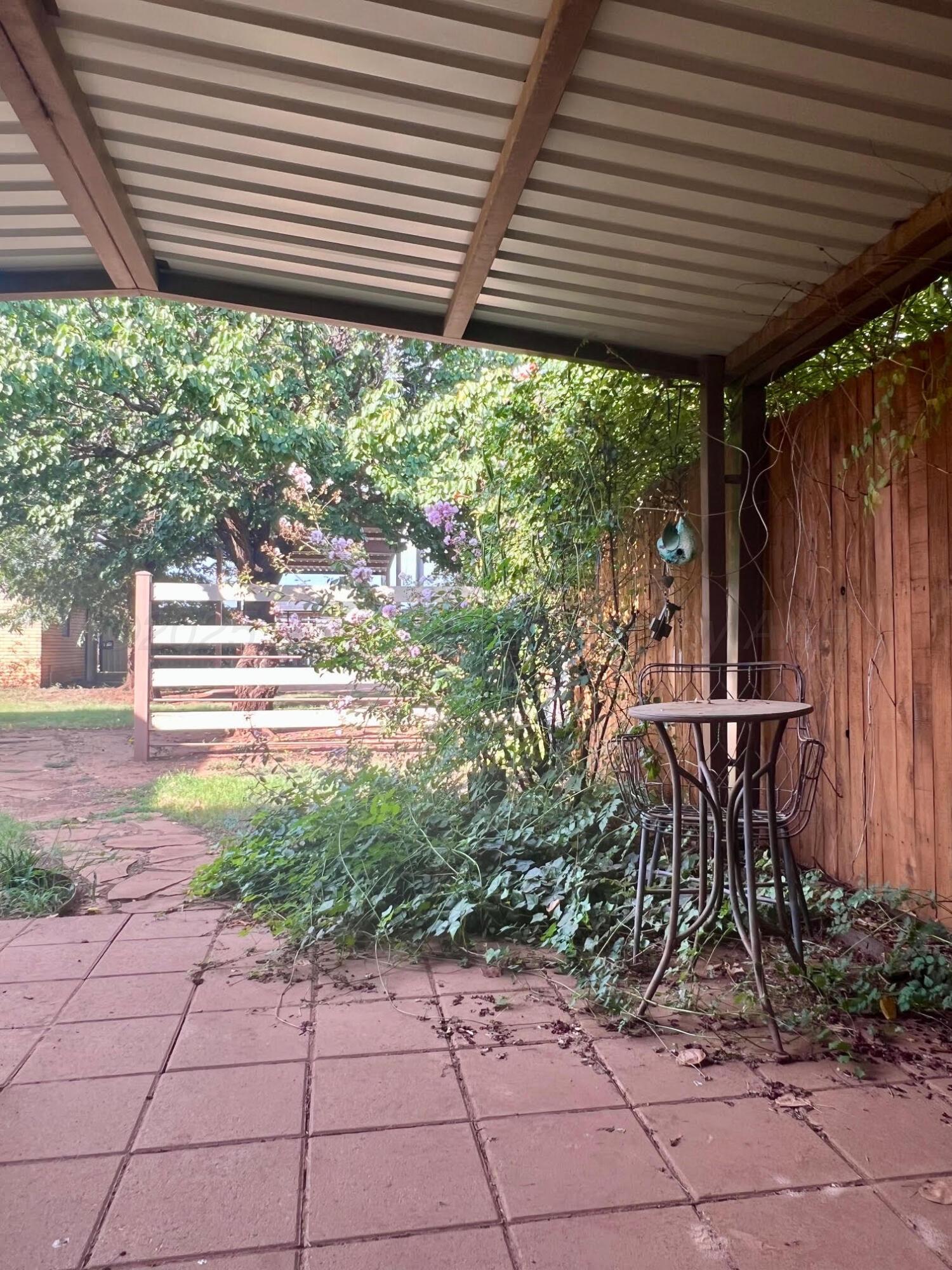 1402 Ave K Northwest Childress, TX 79201 - Photo 21 of 34 a view of a patio with table and chairs and potted plants