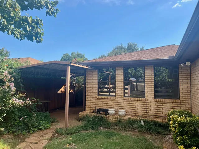 a view of a backyard with sitting area