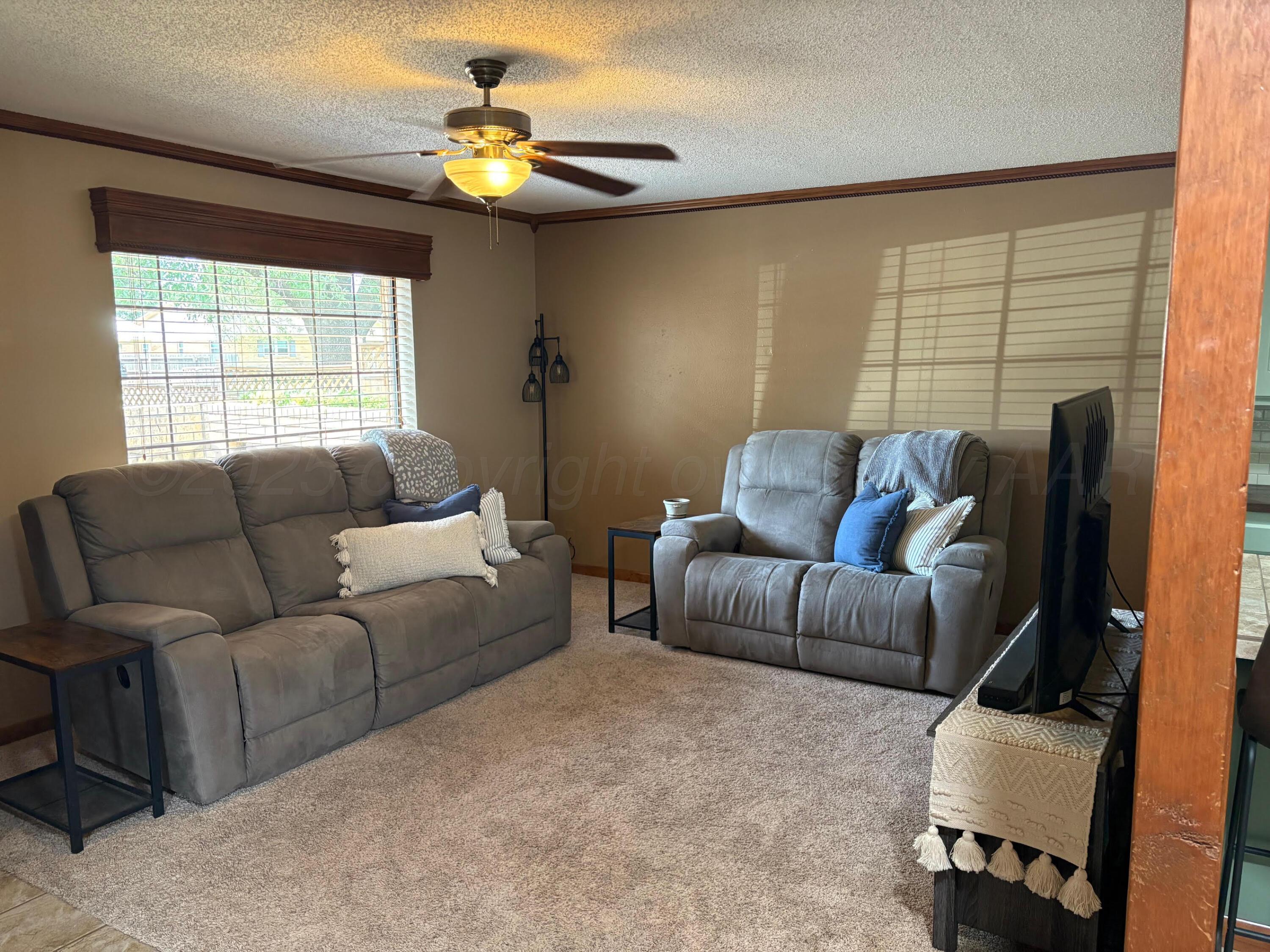 1402 Ave K Northwest Childress, TX 79201 - Photo 3 of 34 a living room with furniture and a window