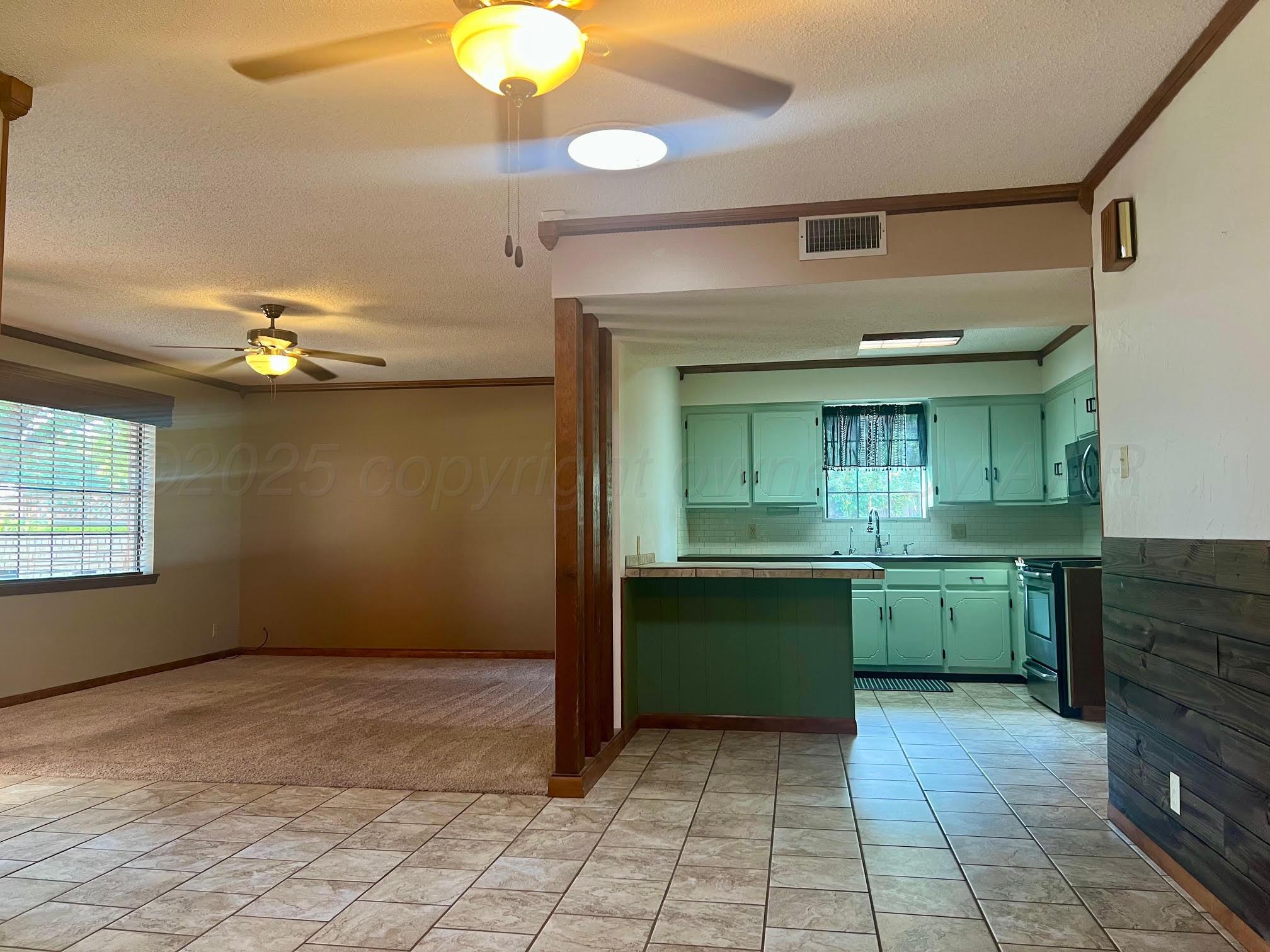 1402 Ave K Northwest Childress, TX 79201 - Photo 4 of 34 a kitchen with a sink and cabinets