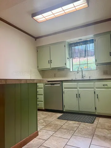 a kitchen with a cabinets a sink and a window