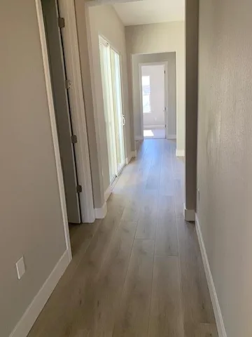 an empty room with wooden floor and a window