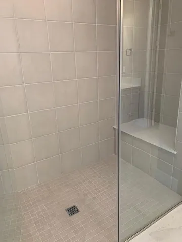 a bathroom with a glass shower door