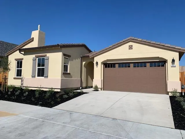 a front view of a house with a garage