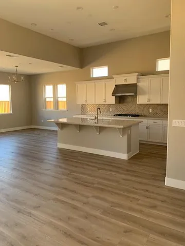a kitchen with stainless steel appliances granite countertop a sink stove and wooden floor