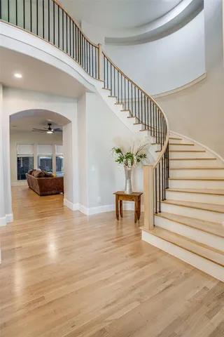 a view of entryway and hall with wooden floor